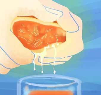 on a blue-green background, pale hands squeeze juice from a bright orange into a cup