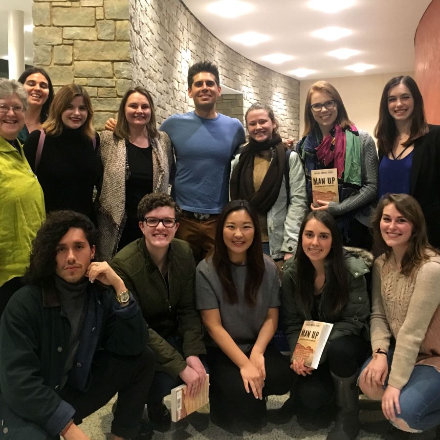 A photo of Carlos Andrés Gómez with Women's Center interns and staff