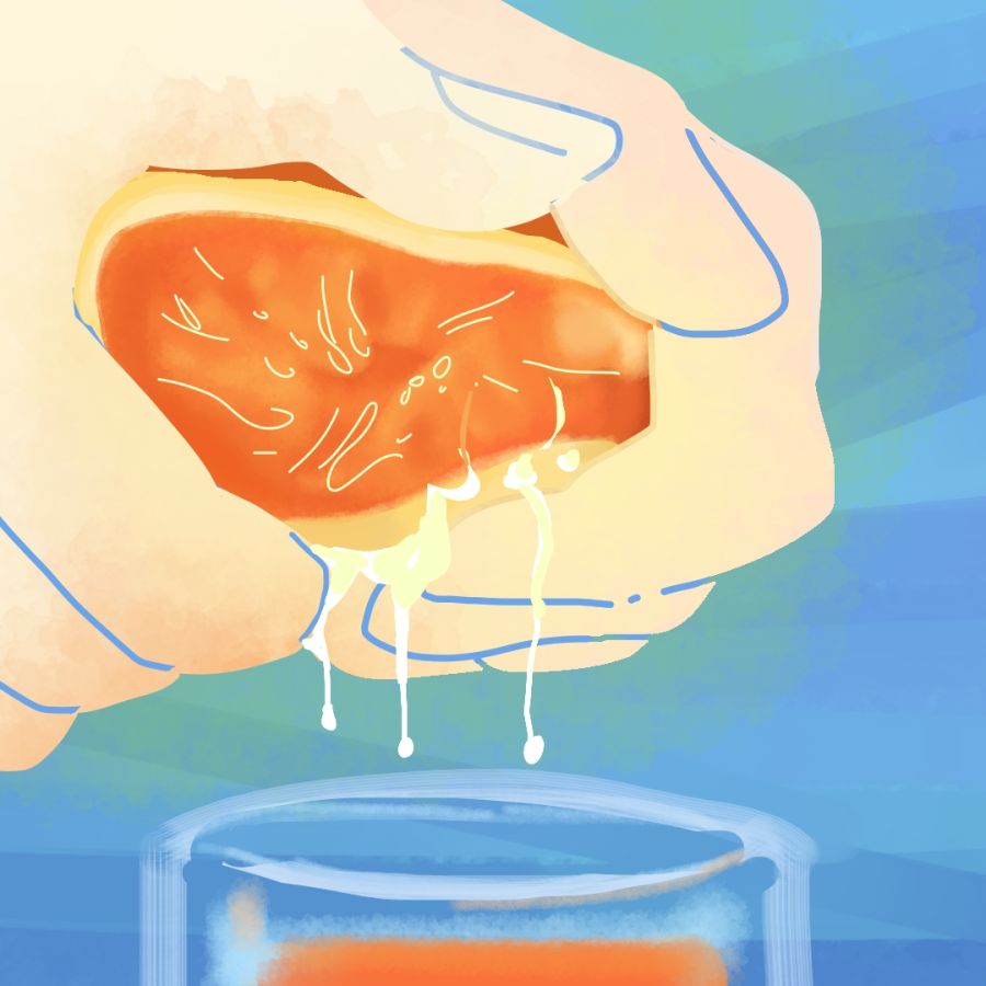 on a blue-green background, pale hands squeeze juice from a bright orange into a cup