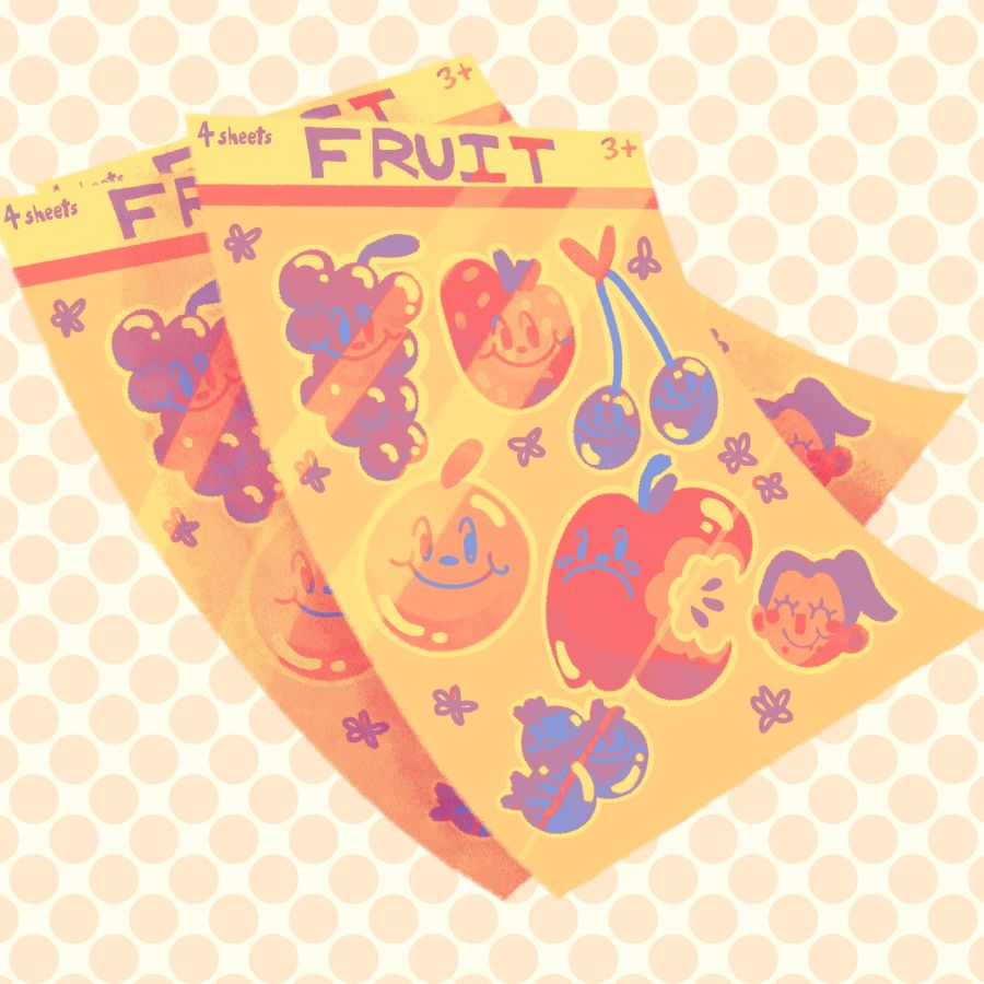 two sheets of colorful fruit stickers on an orange and white background