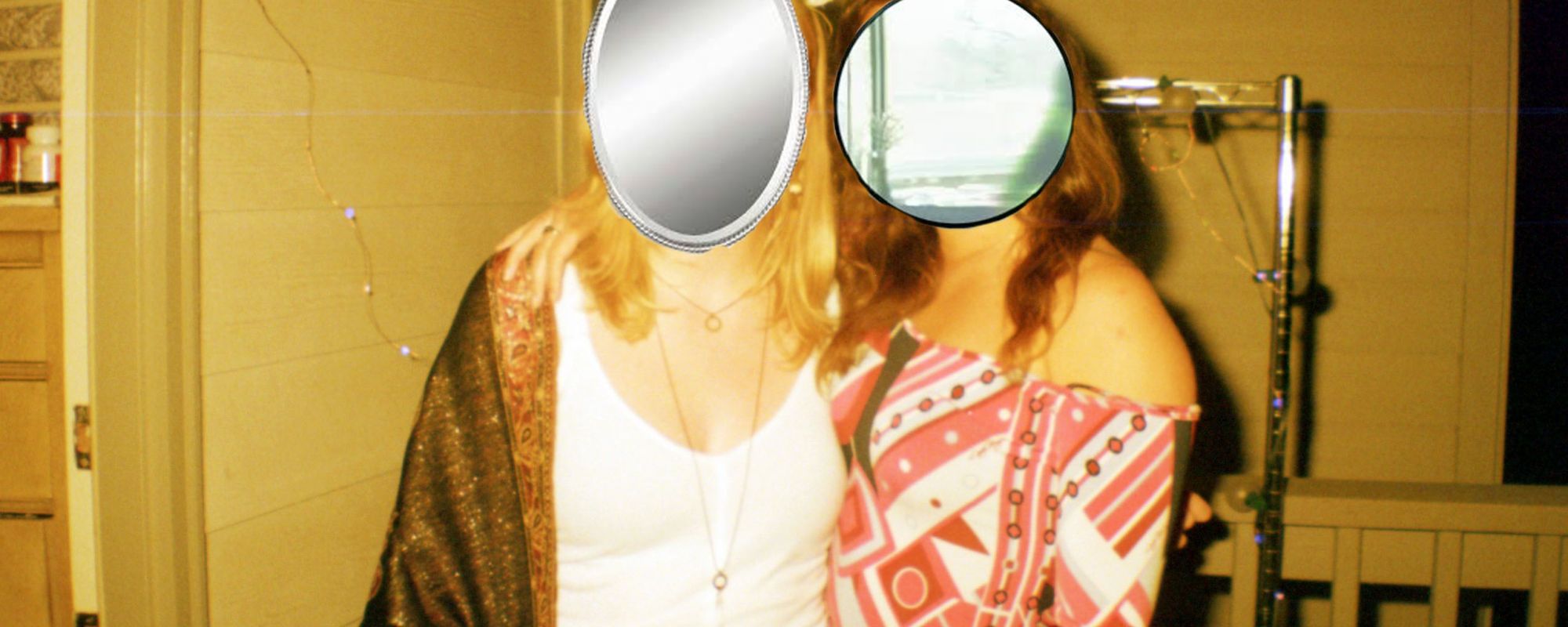 A photo of two women with mirrors where their faces should be.