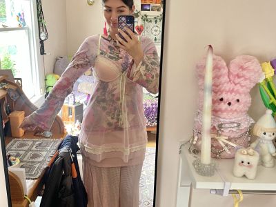 picture of ella wearing flowy pink patterned outfit