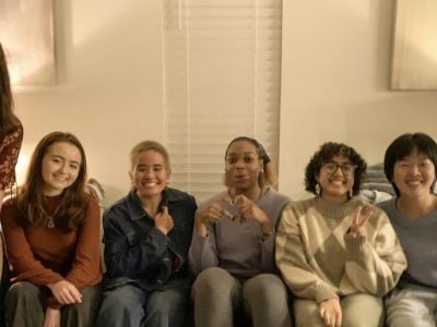 The iris team sitting on a couch smiling