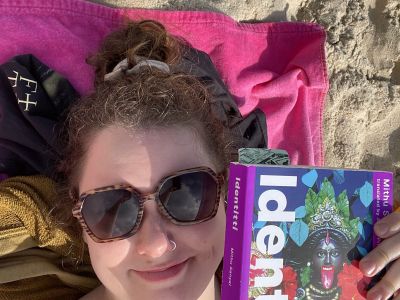 image of Hailey with a book on the beach